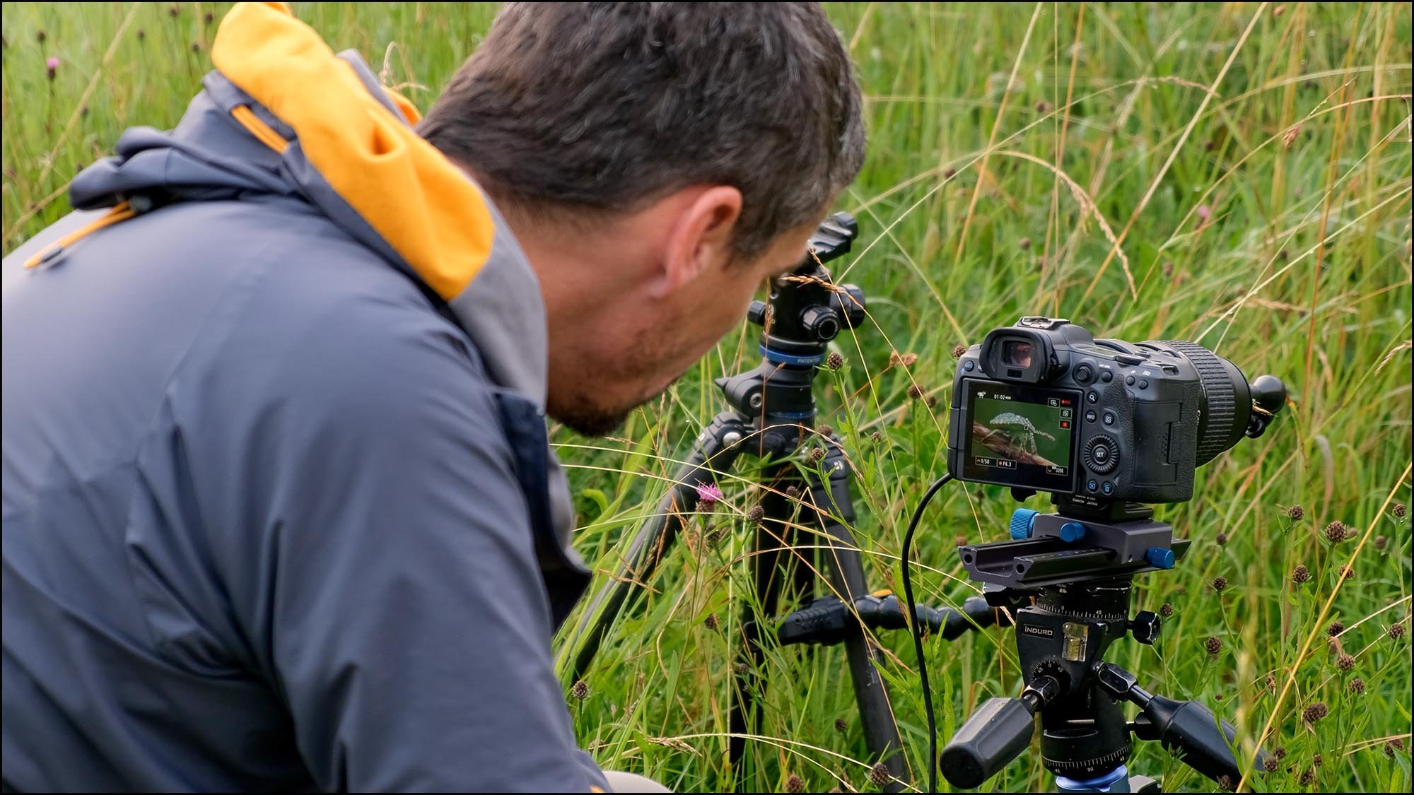 Man taking macro photo with camera on tripod