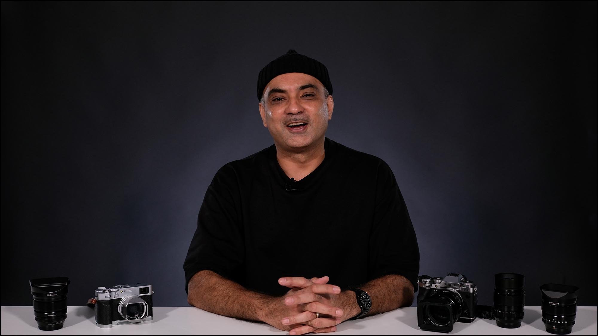 Mr Whisper at desk presenting with camera on the table