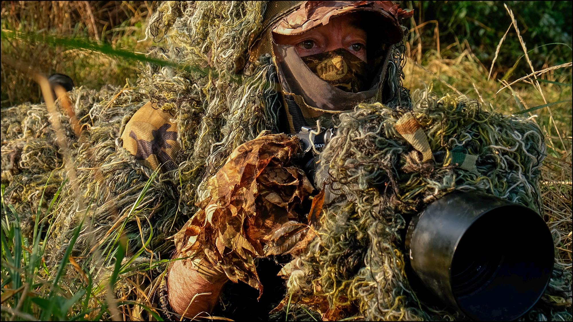 Photographer in camouflage photographing wildlife