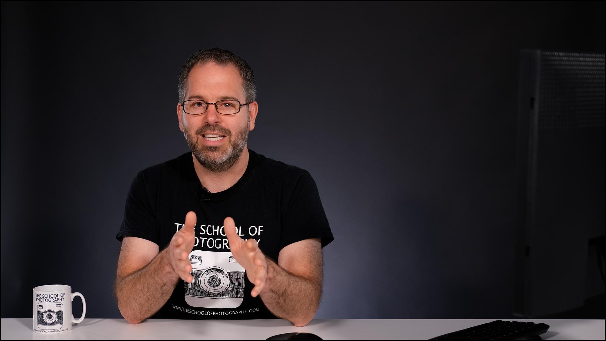 Man teacher talking at camera